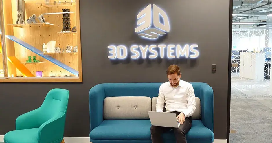 3D Systems 라운지에 앉아 노트북으로 일하고 있는 남성